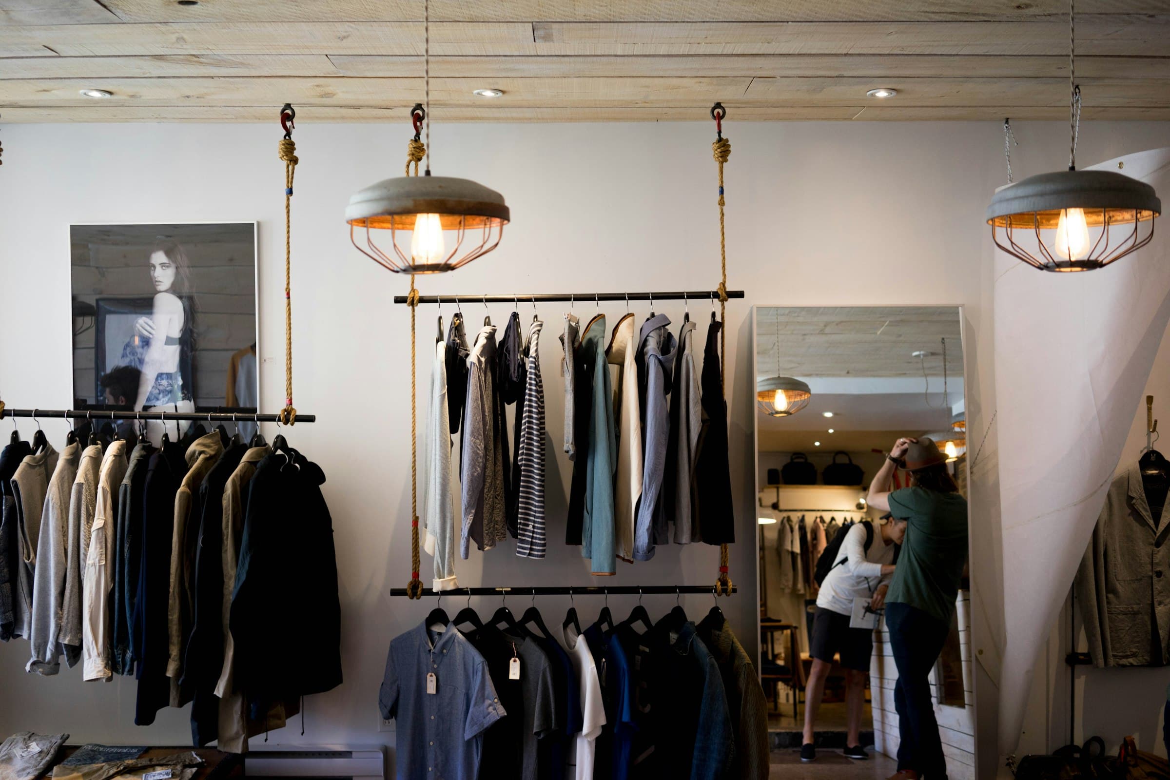 A calm boutique interior with tailored clothes on rails