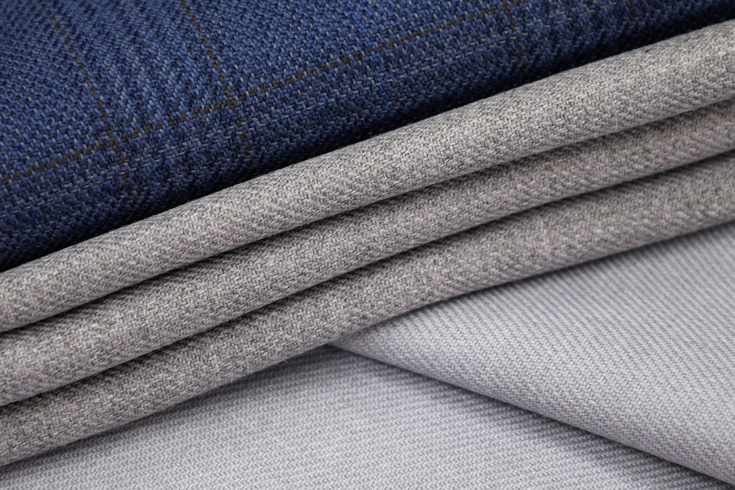 Folded suit cloths in grey and navy